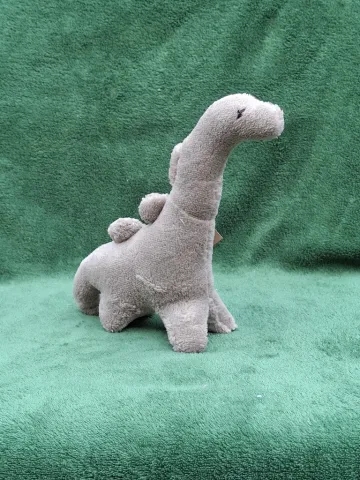 Small grey plush Dinosaur from top