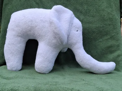 Big white plush sleeper Elephant from side